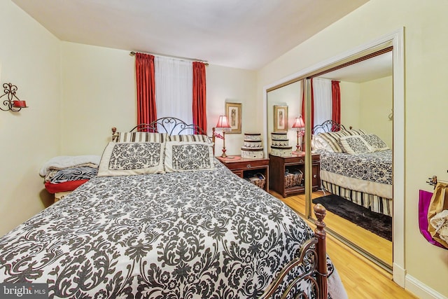 bedroom featuring hardwood / wood-style floors and a closet