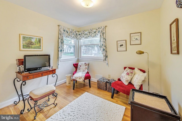 living area with hardwood / wood-style flooring