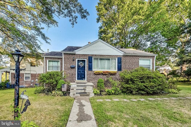 bungalow-style home featuring a front lawn