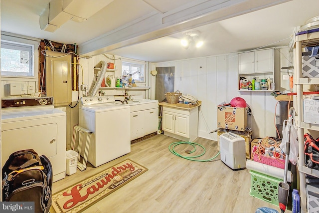 washroom featuring separate washer and dryer and light hardwood / wood-style floors