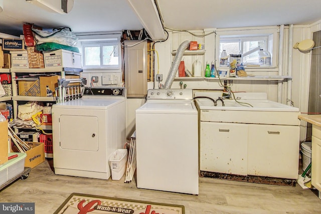 clothes washing area featuring a healthy amount of sunlight and washing machine and clothes dryer