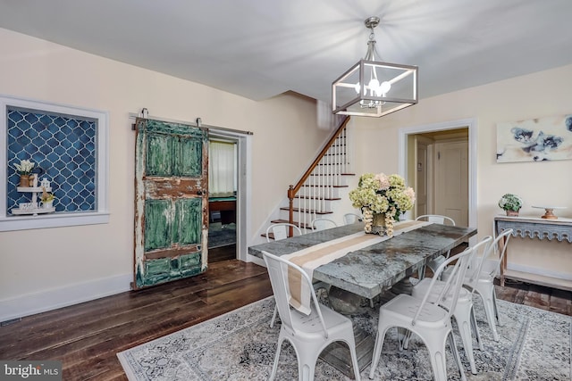 dining area with dark hardwood / wood-style floors and a chandelier