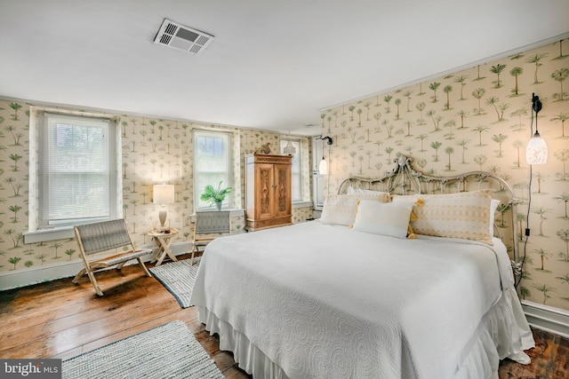 bedroom with dark hardwood / wood-style floors