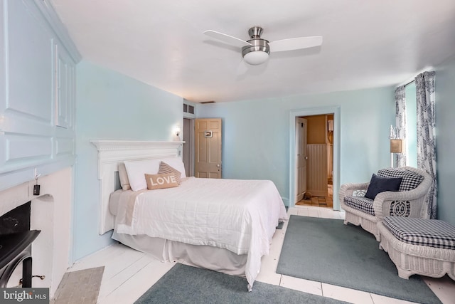 bedroom with ceiling fan and ensuite bath