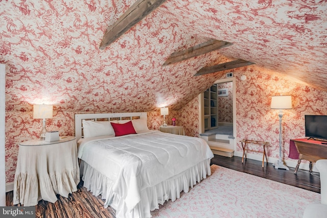 bedroom with vaulted ceiling with beams and wood-type flooring