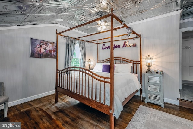 bedroom with dark hardwood / wood-style flooring