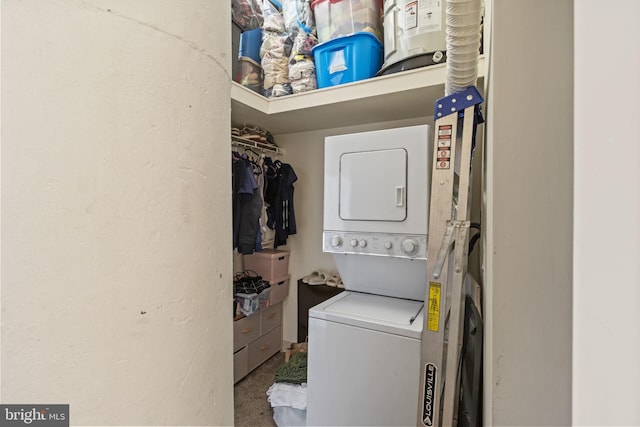 laundry area with stacked washer / drying machine