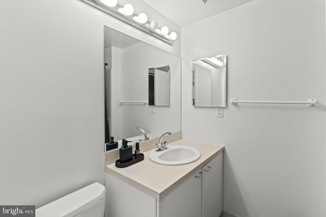 bathroom featuring toilet and vanity