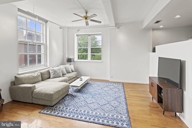 living room featuring ceiling fan, a healthy amount of sunlight, and wood-type flooring