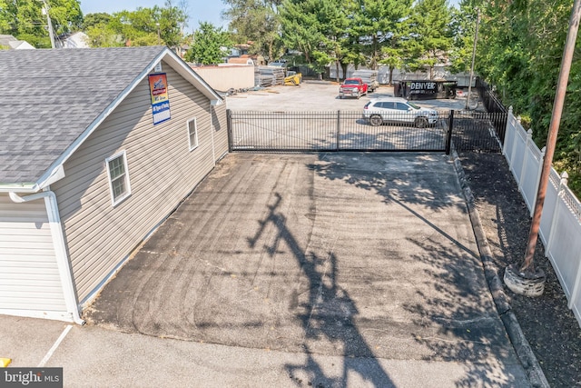 8504 Miramar Rd, Pasadena, MD 21122 - exterior view of a shingled roof, a gate, and a downspout