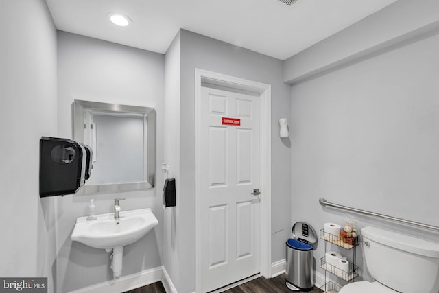 8504 Miramar Rd, Pasadena, MD 21122 - bathroom with wood finished floors, toilet, and baseboards