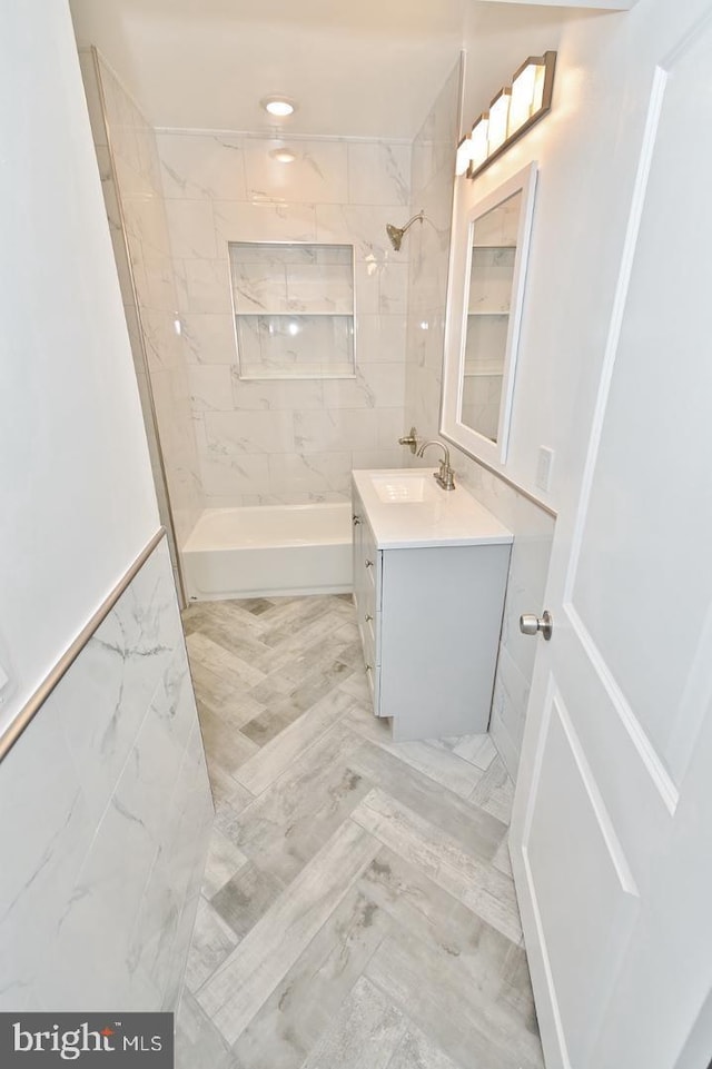 bathroom with vanity and tiled shower / bath combo