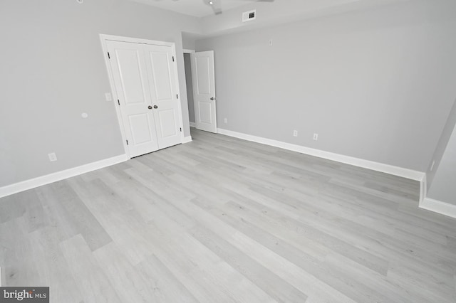 unfurnished room with ceiling fan and light wood-type flooring