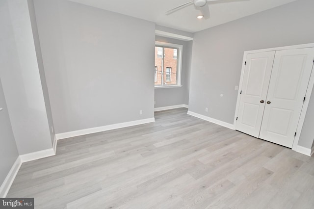 unfurnished bedroom with ceiling fan and light wood-type flooring