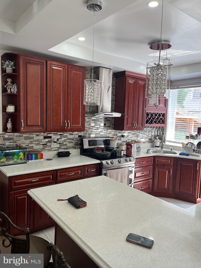 kitchen with tasteful backsplash, sink, hanging light fixtures, stainless steel range with electric cooktop, and wall chimney exhaust hood