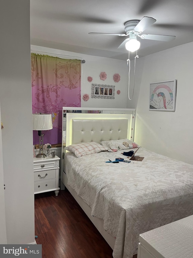 bedroom with dark hardwood / wood-style floors and ceiling fan