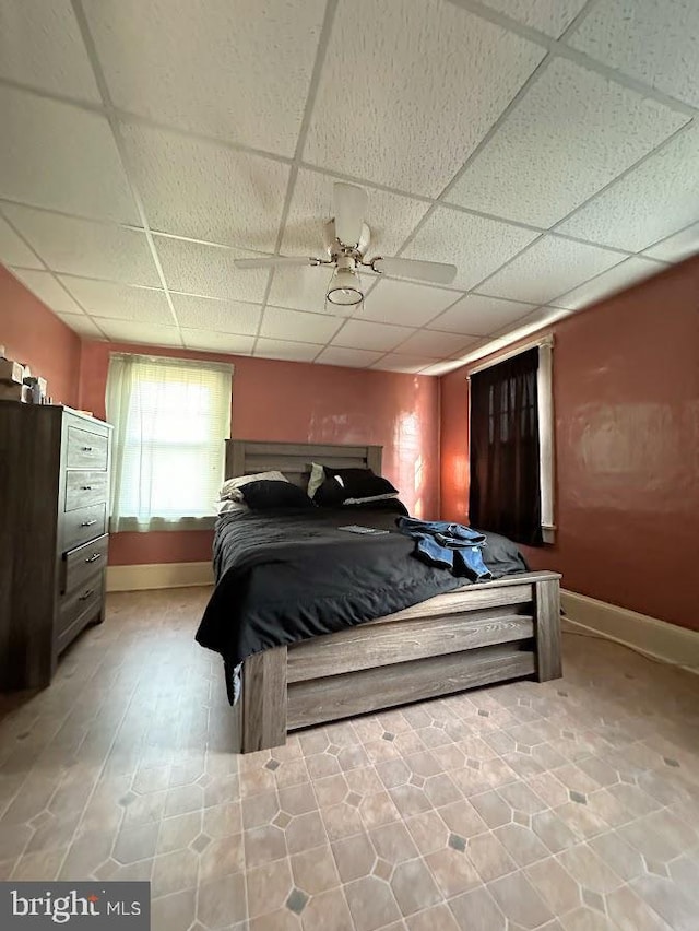 bedroom with a paneled ceiling and ceiling fan