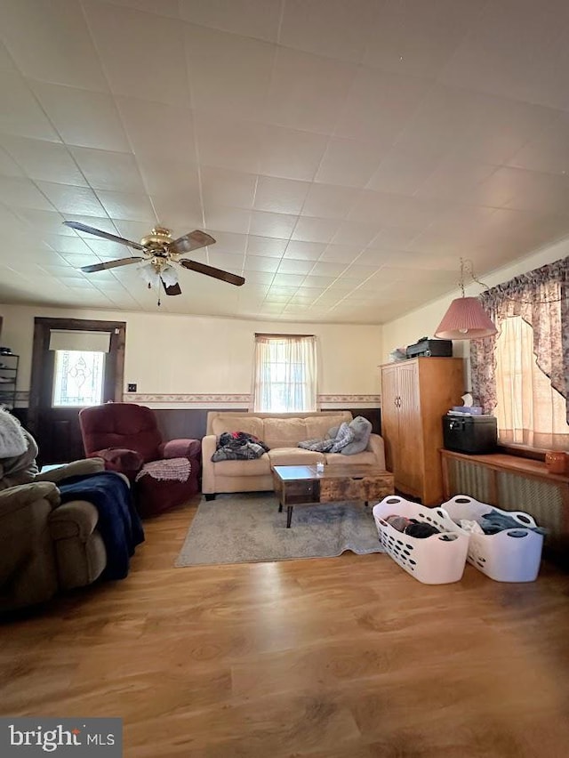 living room with ceiling fan, a healthy amount of sunlight, and hardwood / wood-style flooring