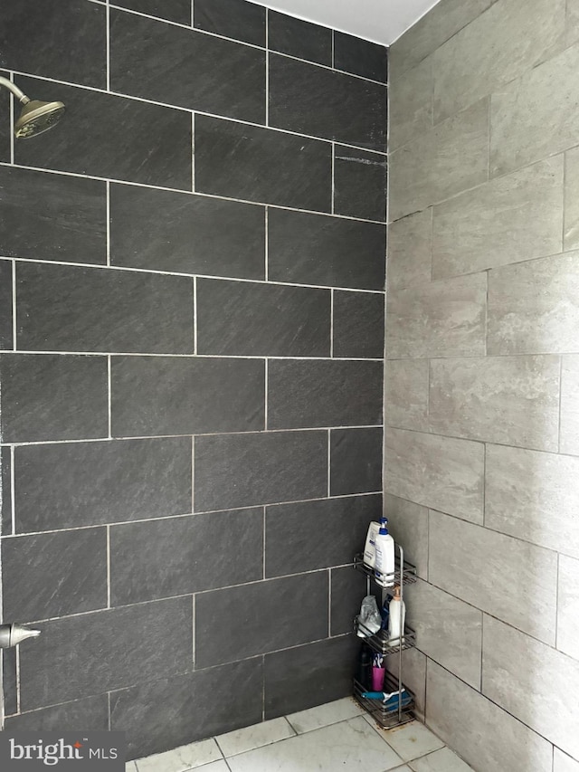 bathroom with tiled shower