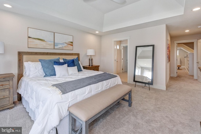 carpeted bedroom featuring a raised ceiling