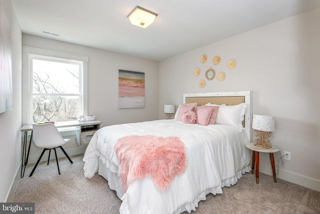 bedroom featuring light carpet