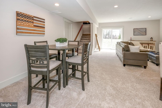 dining area featuring light carpet