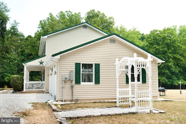 view of side of home with covered porch