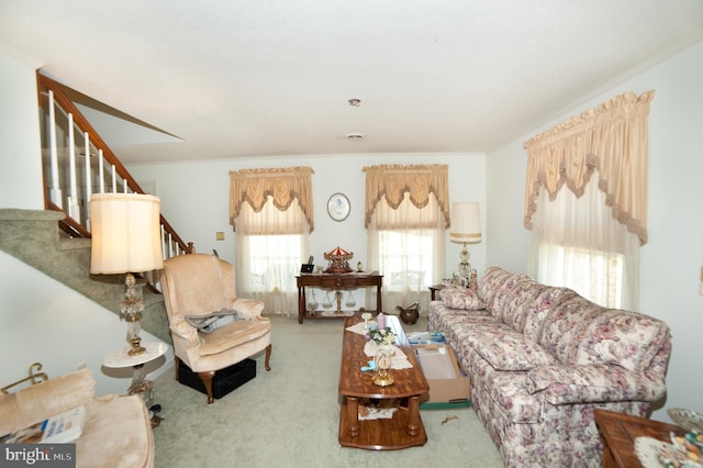 carpeted living room with ornamental molding