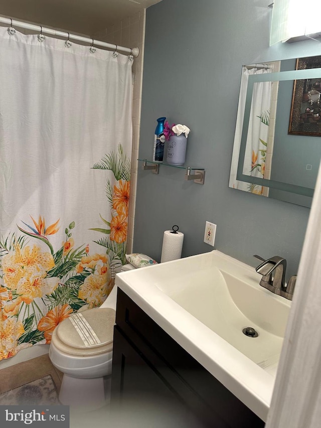 bathroom with vanity, tile patterned floors, and toilet