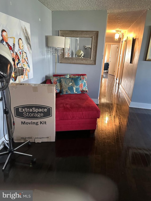 bedroom with a textured ceiling and hardwood / wood-style flooring