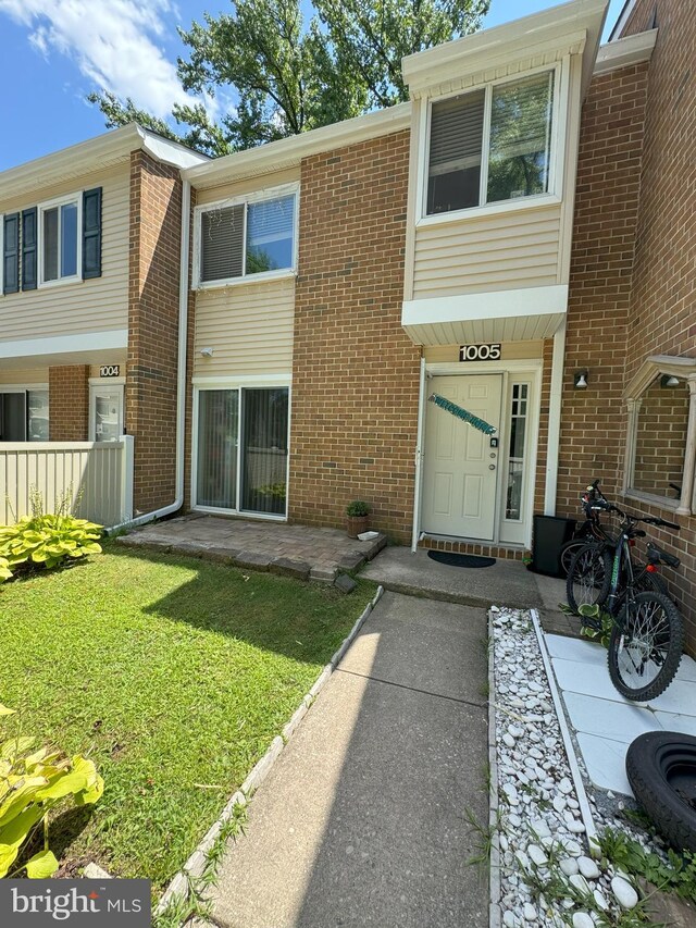 rear view of property featuring a lawn