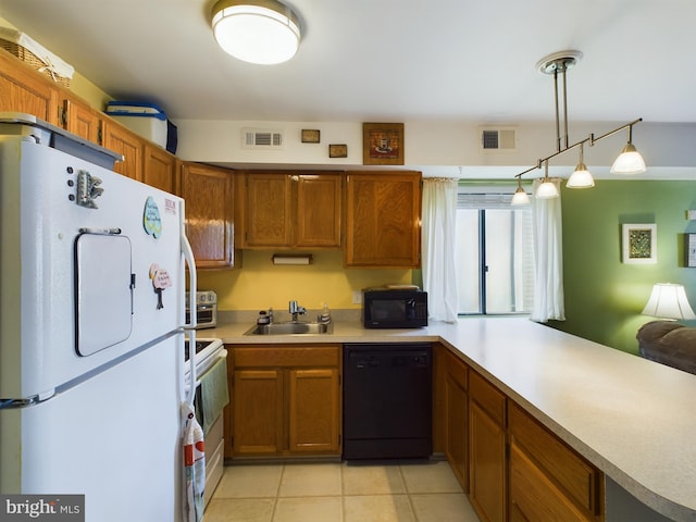 kitchen with black appliances, light countertops, visible vents, and a sink