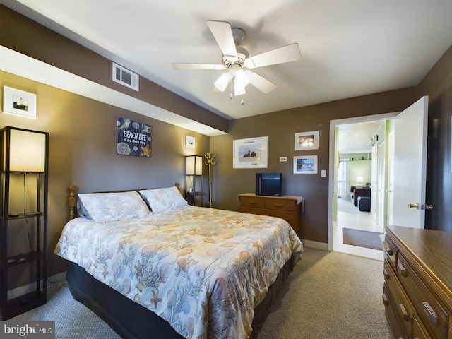 carpeted bedroom with visible vents, ceiling fan, and baseboards