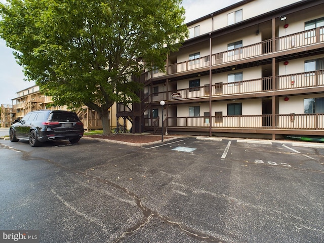 view of building exterior featuring uncovered parking