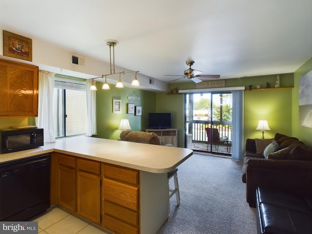 kitchen featuring open floor plan, a peninsula, black appliances, and visible vents