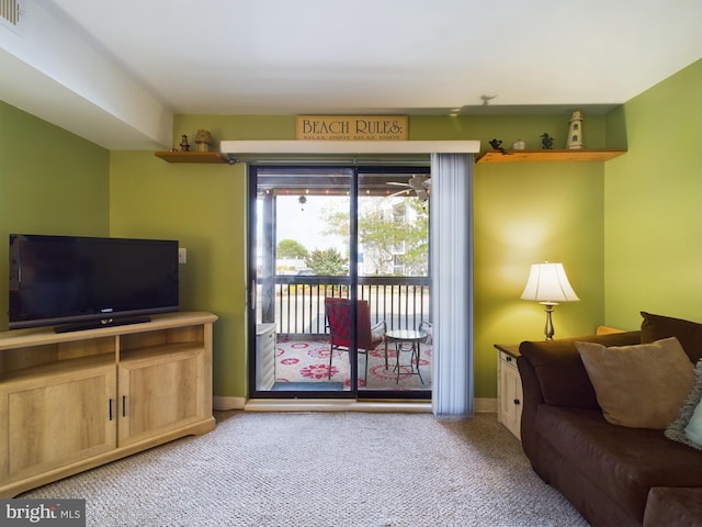 living room with visible vents, light colored carpet, and baseboards