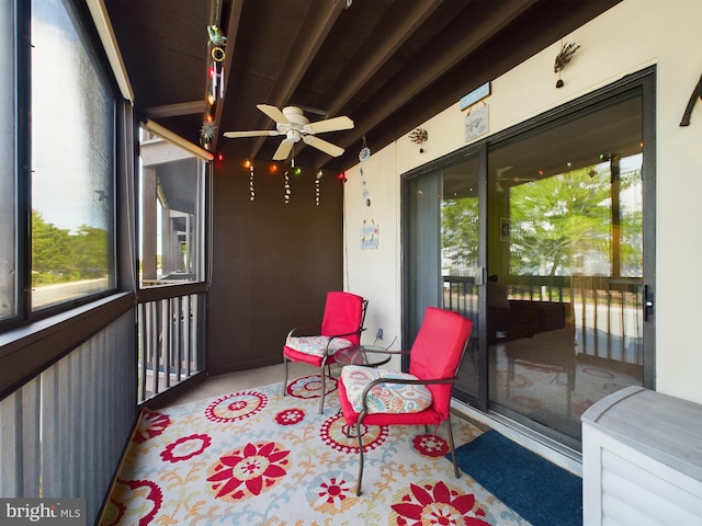 sunroom with plenty of natural light and a ceiling fan