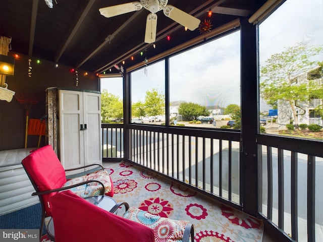 sunroom / solarium featuring ceiling fan