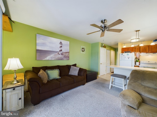 living room featuring light colored carpet and ceiling fan