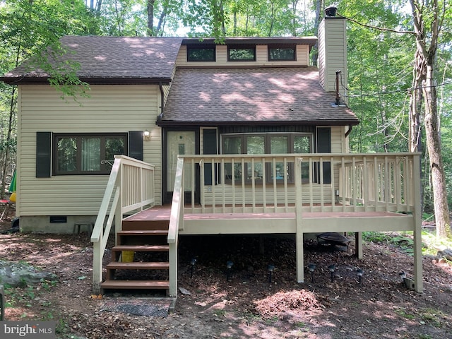 rear view of house featuring a wooden deck