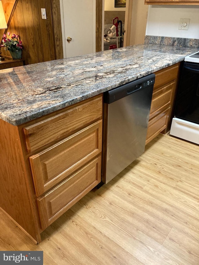 kitchen featuring range with electric cooktop, dark stone counters, dishwasher, and light wood-type flooring