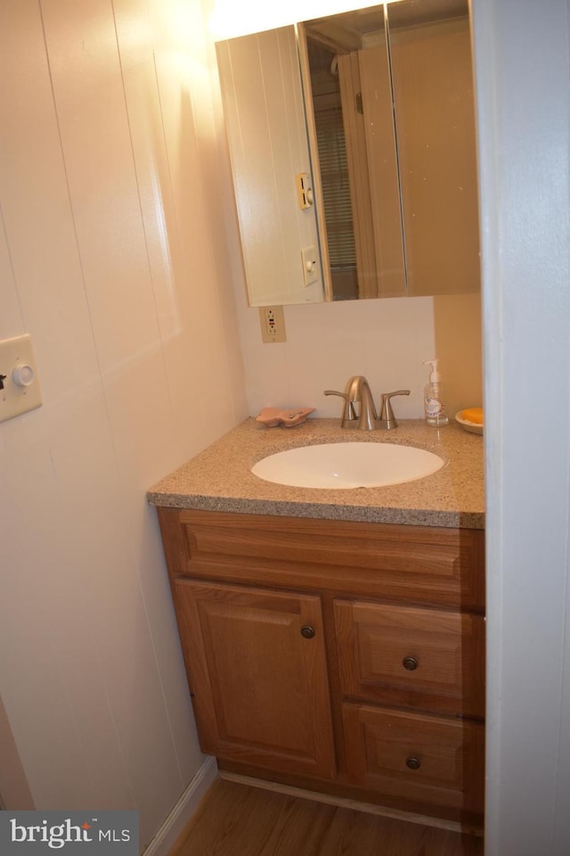 bathroom featuring vanity and wood-type flooring