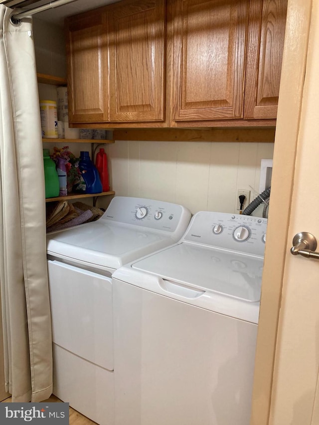 laundry area with cabinets and separate washer and dryer