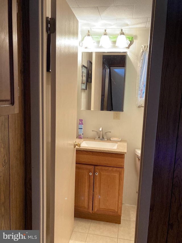 bathroom featuring tile patterned floors, toilet, and vanity