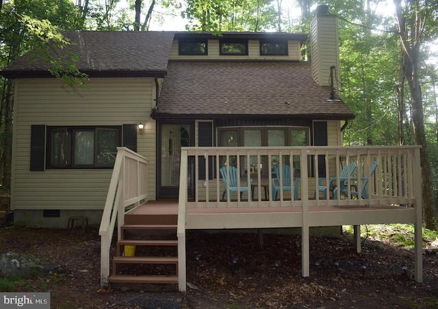 rear view of property with a wooden deck