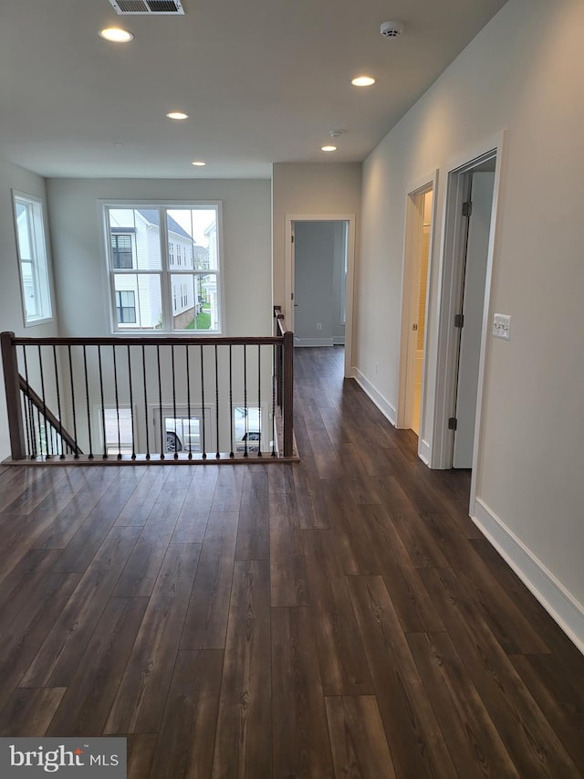 corridor with hardwood / wood-style floors