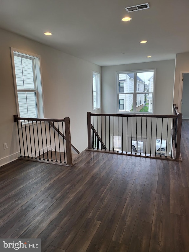 unfurnished room with hardwood / wood-style flooring