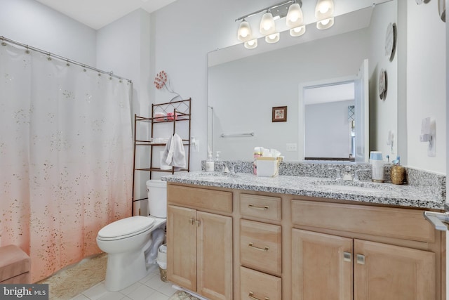 bathroom with toilet, tile patterned flooring, and double sink vanity