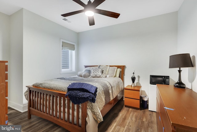 bedroom featuring dark wood-type flooring and ceiling fan