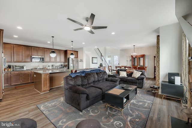 living room with hardwood / wood-style floors and ceiling fan